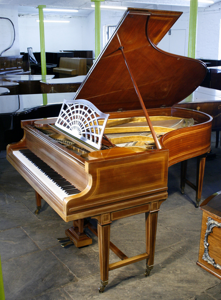 An 1884, Bechstein Model B grand piano with a mahogany case and gate legs, inlaid with satinwood stringing. Piano has an eighty-eight note keyboard and a two-pedal lyre