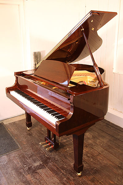 Brand new, Steinhoven Model 148 baby grand piano with a mahogany case and polyester finish. Piano has an eighty-eight note keyboard and a three-pedal piano lyre.