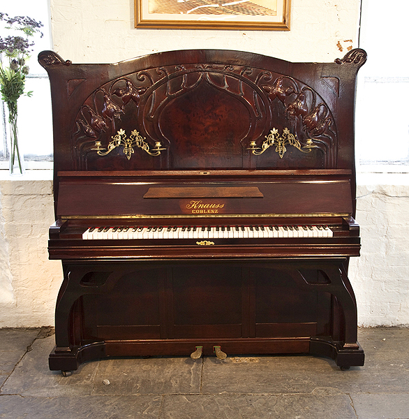 A 1912, Art Nouveau style, Knauss upright piano for sale with a mahogany case carved with flowers and flowing tendrils