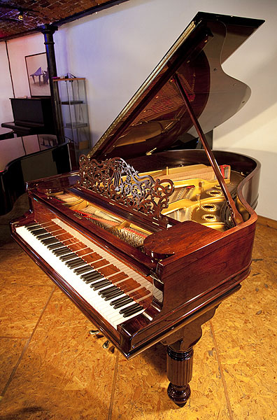 A 1900, Steinway Model A grand piano with a rosewood case, filigree music desk and elephant legs
