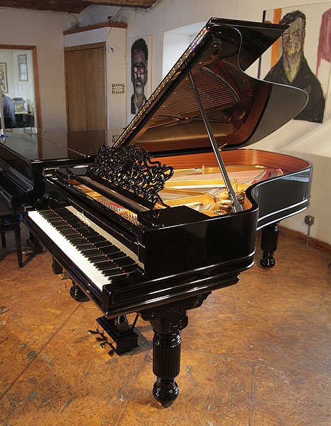 An 1886, Steinway Model B grand piano with a black case, filigree music desk and fluted, barrel legs. Piano has an eighty-five note keyboard and a two-pedal lyre.