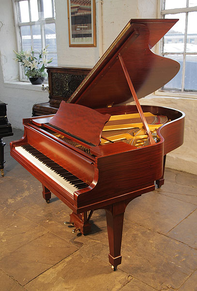 A rebuilt, 1926, Steinway Model M grand piano with a mahogany case and spade legs. Piano has an eighty-eight note keybaord and a two-pedal lyre.