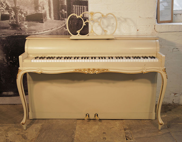A 1968, Hornung and Moller upright piano with a Louis XV, Rococo style case. Piano has an eighty-five note keyboard and two pedals. 