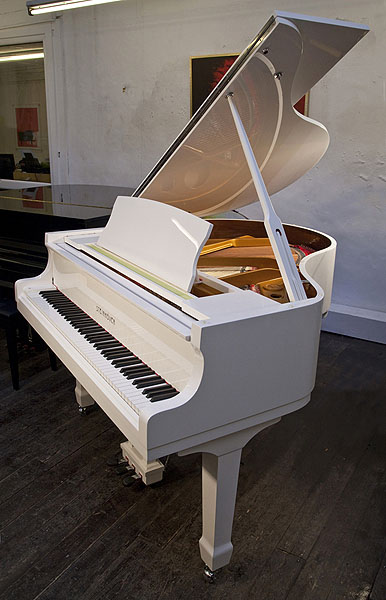 Brand new Steinhoven Model 148 baby grand piano with a white case and polyester finish. Piano has an eighty-eight note keyboard and three-pedal lyre.
