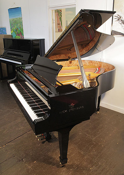 A brand new, Steinberg WS-M170 grand piano with a black case and brass fittings. Eighty-eight note keyboard and three-pedal lyre.