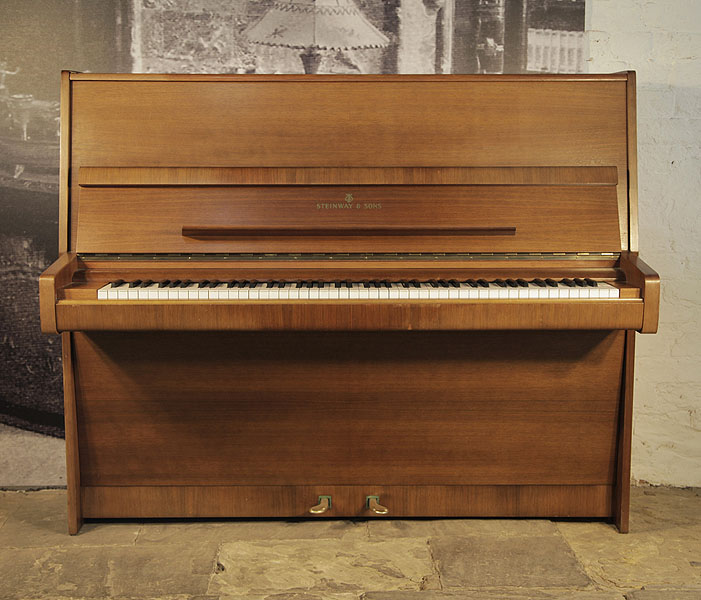 A 1976, Steinway Model V upright piano with a polished, mahogany case.