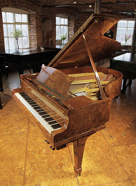 A 1938, Steinway Model O grand piano with a burr walnut case and spade legs. Piano has an eighty-eight note keyboard and a two-pedal lyre.