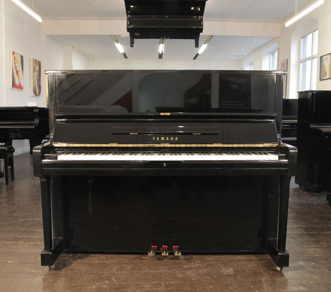 A 1991, Yamaha U10A upright piano with a black case and polyester finish. Piano has an eighty-eight note keyboard and three pedals.