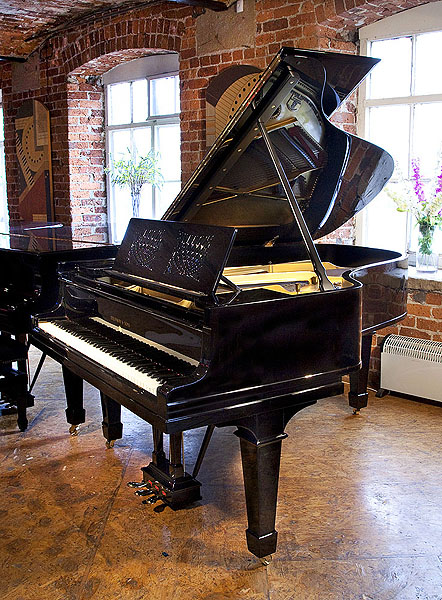A 1914, Steinway Model A grand piano with an ebonised case and spade legs. Music desk features an elegant, geometric cut-out design. 