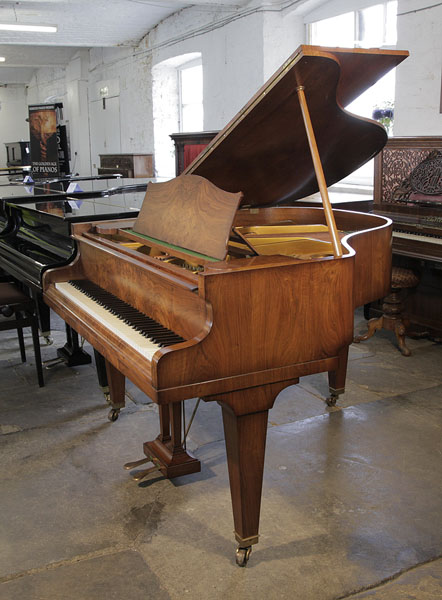 A pre-owned, Bechstein Model S baby grand piano with a figured walnut case and tapered legs