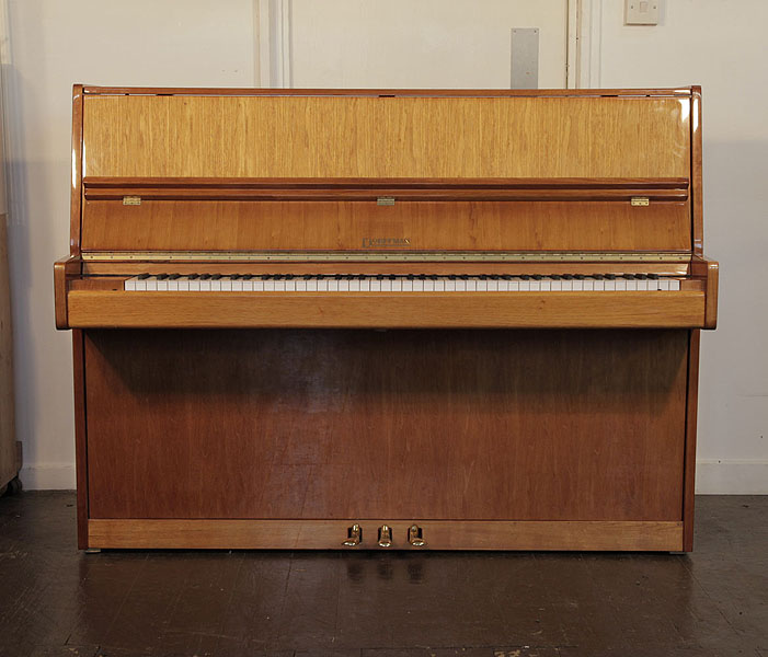 Dorffman upright piano with a walnut case. Piano has an eighty-eight note keyboard and three pedals 