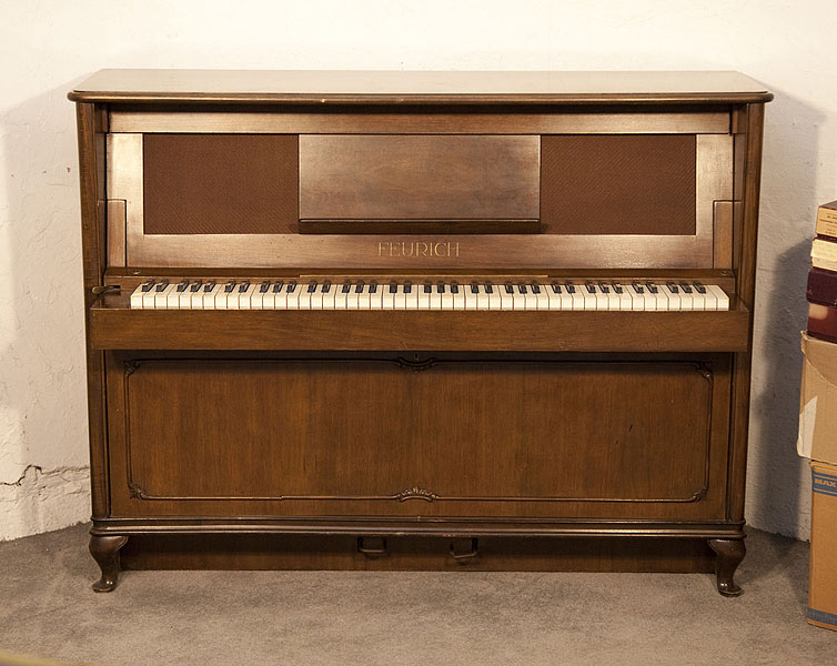 A 1937, Feurich ship upright piano with a walnut case, folding keyboard and wickerwork front panel. Piano has an eighty-eight note keyboard and two pedals