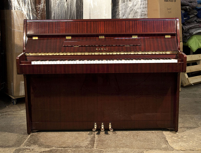 A Kawai CE-7N Upright Piano For Sale with a Mahogany Case and Brass Fittings. Piano has an eighty-eight note keyboard and three pedals 