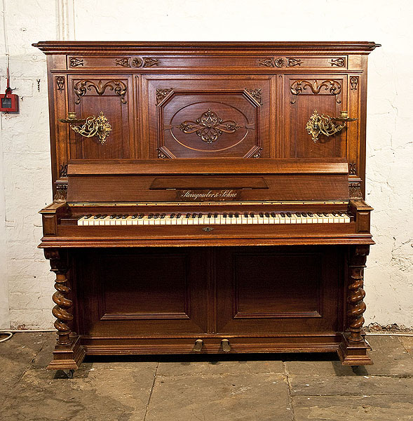  Steingraeber upright piano with a Neoclassical style, carved mahogany case and barley twist legs Piano has an eighty-five note keyboard and two pedals