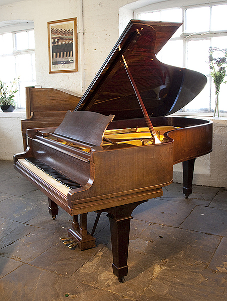 A 1923, Steinway Model B grand piano with a mahogany case and spade legs. Piano has a three-pedal lyre and an eighty-eight note keyboard.