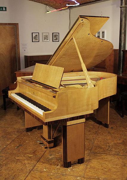 Art-Deco style, restored, 1932, Steinway Model M grand piano for sale with a crossbanded, maple and coromandel case. Cabinet features strong geometric styling. Piano has an eighty-eight note keybaord and a two-pedal lyre.