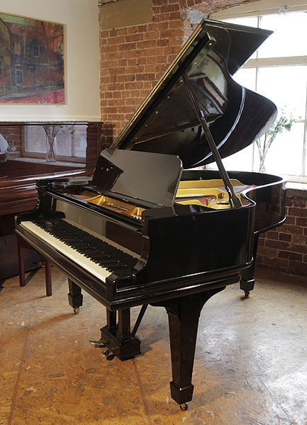 A 1909, Steinway Model O grand piano with a black case and spade legs. Piano has an eighty-eight note keyboard and a two-pedal lyre.  