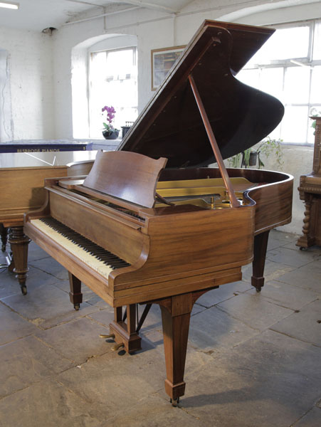 A 1926, Steinway Model O grand piano with a mahogany case and spade legs. Piano has an eighty-eight note keyboard and a two-pedal lyre.