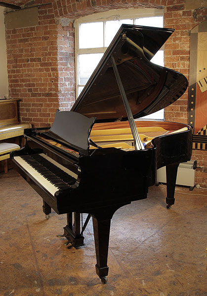 A 1974, Steinway Model O grand piano with a black case and spade legs. Piano has an eighty-eight note keyboard and a two-pedal lyre. 