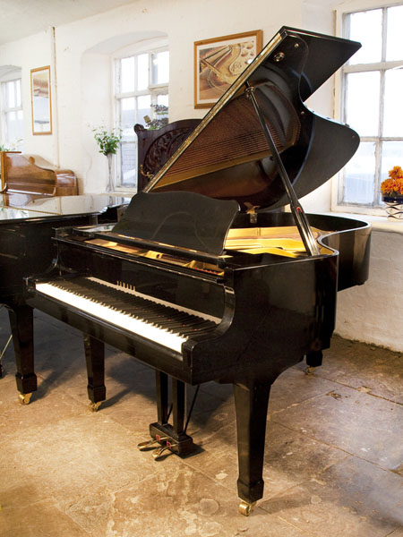 A 1979, Yamaha G3 grand piano for sale with a black case and spade legs. Piano has an eighty-eight note keyboard and a two-pedal lyre. 