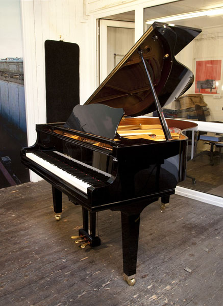 A Yamaha GC1 baby grand piano for sale with a black case and square, tapered legs. Piano features a Quiettime Magic Star system. Piano has an eighty-eight note keyboard and a three-pedal lyre 