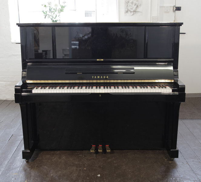 A 1983, Yamaha UX-3 upright piano for sale with a black case and brass fittings. Piano has an eighty-eight note keyboard and three pedals. 