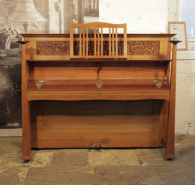  Arts and Crafts style, 1898, Bechstein upright piano with a walnut case and ornate fretwork panel cut in a sinuous floral design