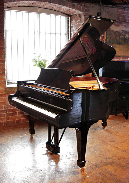 A rebuilt, 1923, Steinway Model O grand piano with a black case and spade legs. Piano has an eighty-eight note keyboard and a two-pedal lyre.  