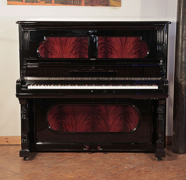 Antique, 1894, Steinway upright piano for sale with a black case and flame mahogany panels. Piano has an eighty-eight note keyboard and two pedals.