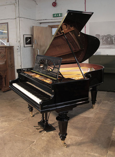 Restored, Bechstein Model A grand piano with a black case and turned faceted legs. Music desk is in an openwork slatted design with central sunburst motif. Piano has an eighty-five note keyboard and a two-pedal lyre.