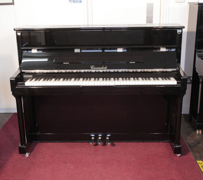 Pre-owned, Cavendish  Classic upright piano with a black case and chrome fittings. Piano has an eighty-eight note keyboard and three pedals. 
