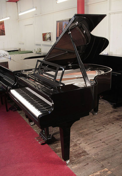 Brand new, Feurich Model 179 Dynamic II grand piano with a black case, openwork music desk and gun metal frame. Piano music desk features an adjustable LED strip light. Piano has an eighty-eight note keyboard and a three-pedal piano lyre
