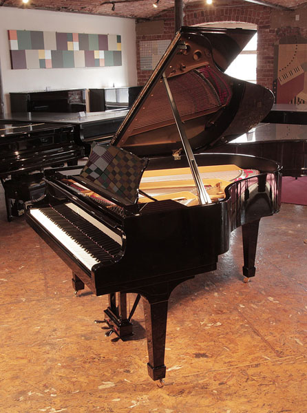 Rebuilt, 1956, Steinway Model M grand piano for sale with a black case and spade legs.  Piano has been rebuilt in Germany by Steinway Academy trained technicians using 100% Steinway parts 