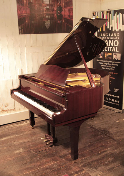 Reconditioned, 1992, Yamaha G1 baby grand piano with a mahogany case and spade legs. Piano has an eighty-eight note keyboard and a three-pedal lyre.  