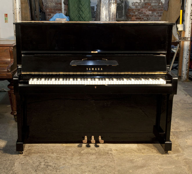 Reconditioned, 1974, Yamaha U1 upright piano for sale with a black case and brass fittings. Piano has an eighty-eight note keyboard and three pedals.  