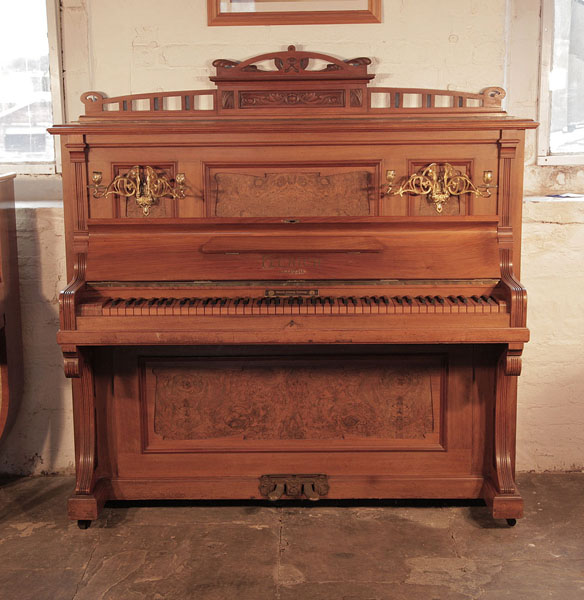 Reconditioned, 1908, Feurich upright piano with a walnut case, burr walnut panels and an unusual walnut keyboard Piano has an eighty-five note keyboard and two pedals