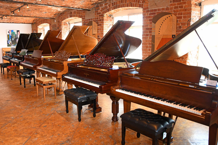 A line of Steinway grand pianos in the Steinway showroom