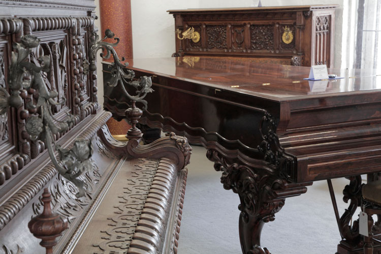 A collection of antique and decorative art cased pianos