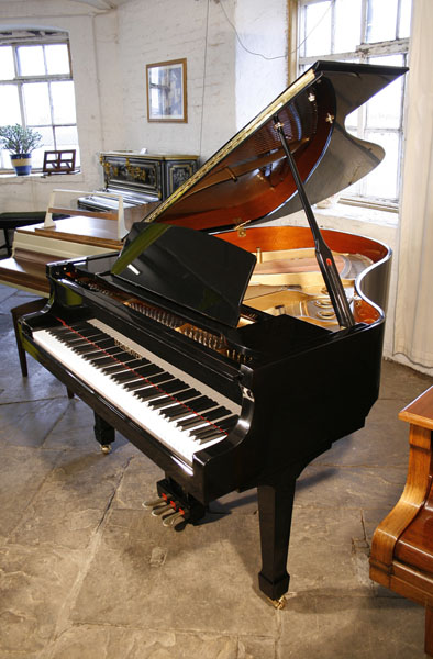 Brand new, Steinhoven Model 170 baby grand piano with a black case and brass fittings.  Piano has an eighty-eight note keyboard and a three-pedal piano lyre. 