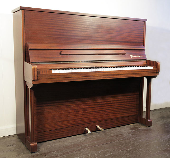 A 1985, Bosendorfer upright piano with a mahogany case. Piano has an eighty-eight note keyboard and two pedals