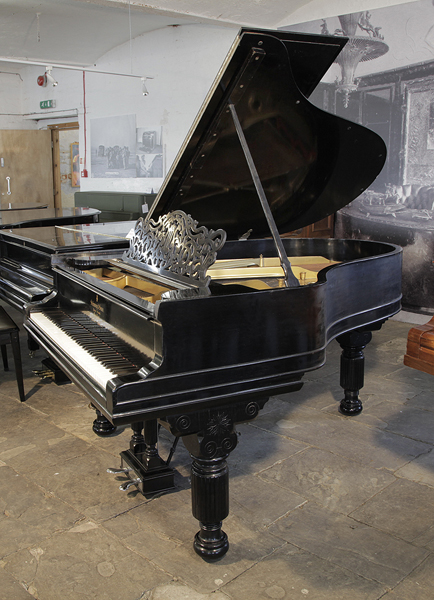 An unrestored, 1886, Steinway Model A grand piano for sale with a black case, filigree music desk and fluted, barrel legs. Piano has an eighty-five note keyboard and a two-pedal lyre.
