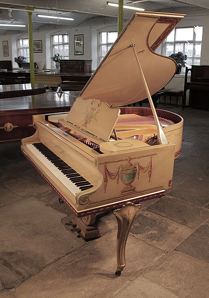 Beuloff baby grand piano with a cream case and cabriole legs. Entire cabinet hand-painted with Classical style motifs signed by Jade 85 Wigmore Street. Piano has an eighty-eight note keyboard and a two-pedal lyre