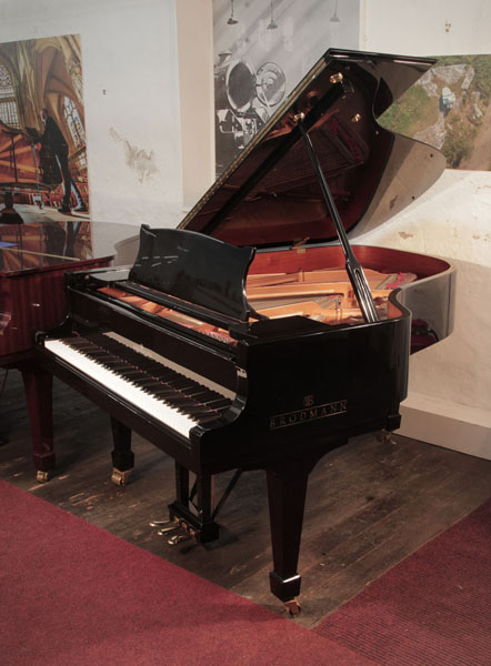 Reconditioned, 2014, Brodmann BG-187 grand piano for sale with a black case and spade legs. Piano has an eighty-eight note keyboard and a three-pedal lyre.  