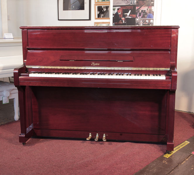 Reconditioned, 1999,    Boston UP-118E  upright piano for sale with a mahogany gloss case and brass fittings. Piano has an eighty-eight note keyboard and three pedals