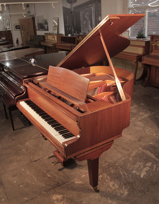  Reconditioned, 1975,  Broadwood baby  grand piano for sale with a mahogany case and square, tapered legs. Piano has an eighty-eight note keyboard and a two-pedal lyre. 