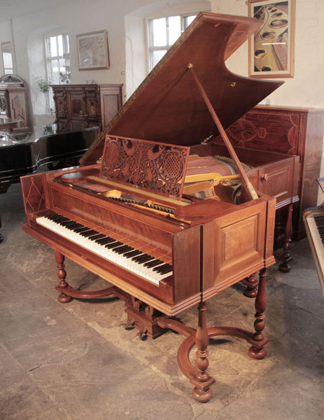 A 1912, Schiedmayer model 15 grand piano for sale with a harpsichord style mahogany cabinet and eight baluster legs attached to a cross stretcher. Piano has an eighty-eight note keyboard and a two-pedal lyre.