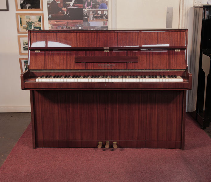 Reconditioned, 1972, Schiedmayer upright piano with a mahogany case and polyester finish. Piano has an eighty-eight note keyboard and three pedals