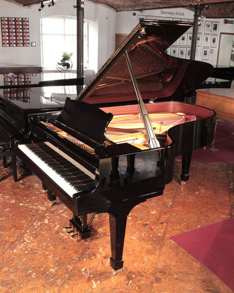  Reconditioned, 2008, Steinway Model B grand piano for sale with a black case and spade legs. Piano has a three-pedal lyre and an eighty-eight note keyboard. 