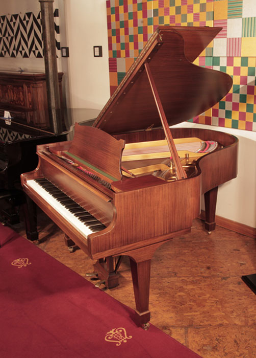 Restored 1961, Steinway Model M grand piano with a satin, walnut case and spade legs. Piano has an eighty-eight note keyboard and a two-pedal lyre.