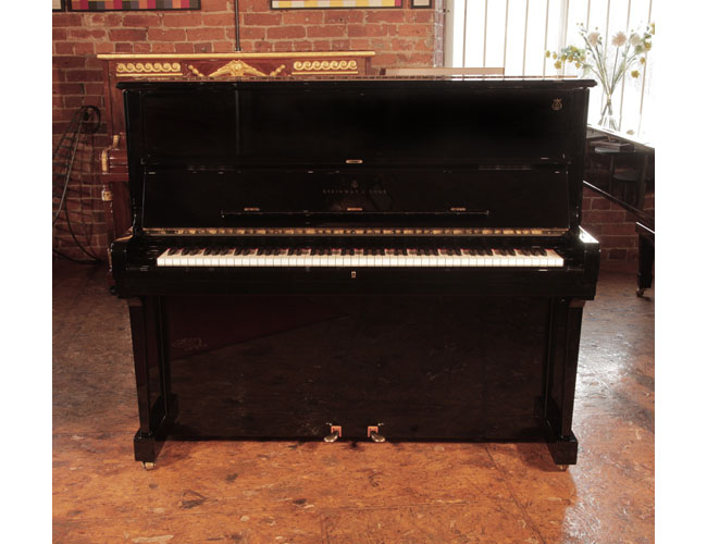Reconditioned, 2002, Steinway Model V upright piano with a polished, black case with brass fittings. Piano frame signed by Lang Lang. Piano has an eighty-eight note keyboard and two pedals. 